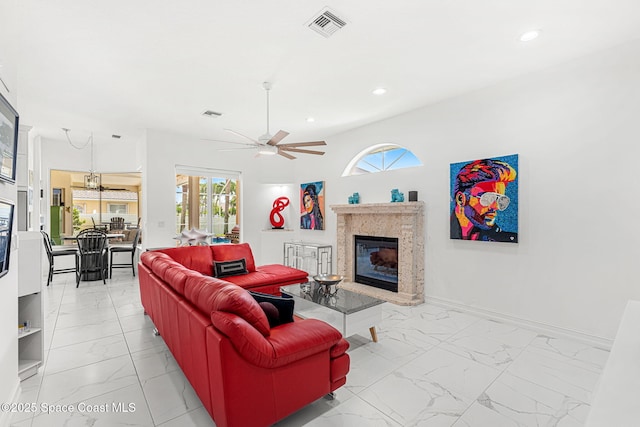 227 Loggerhead Dr, Melbourne Beach, FL 32951 - living area with light marble finish flooring, a fireplace, healthy amount of natural light, and recessed lighting