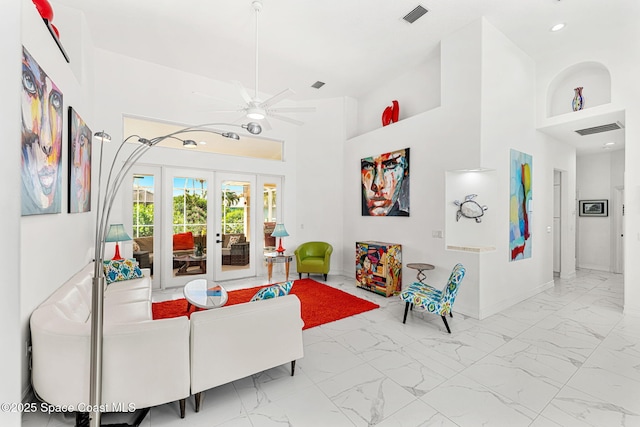 227 Loggerhead Dr, Melbourne Beach, FL 32951 - living room with marble look tiles, ceiling fan, french doors, a high ceiling, and recessed lighting