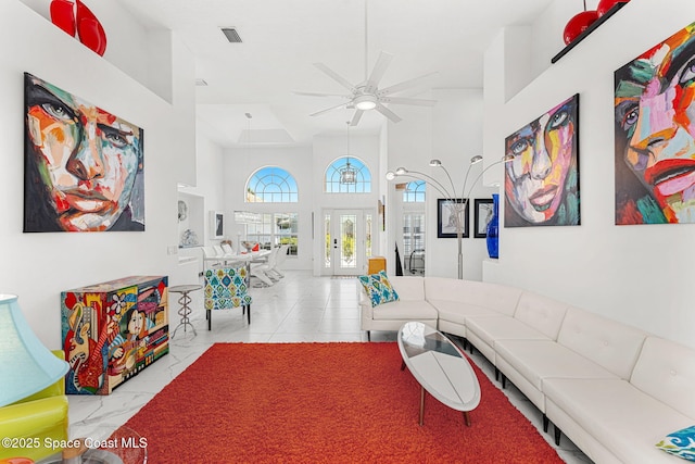 227 Loggerhead Dr, Melbourne Beach, FL 32951 - living area with a ceiling fan, a towering ceiling, french doors, and marble finish floors