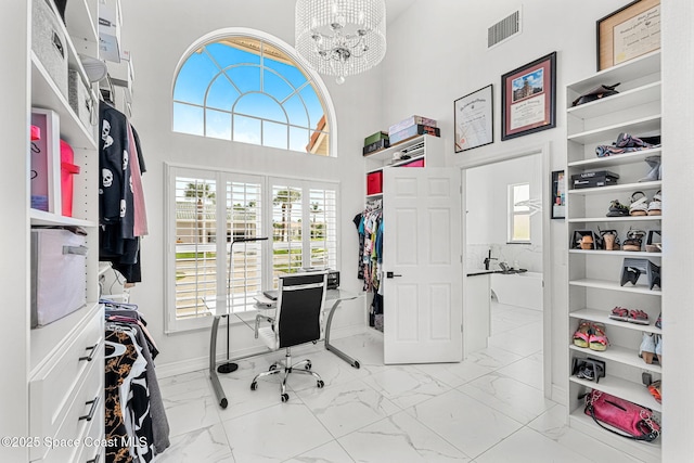 227 Loggerhead Dr, Melbourne Beach, FL 32951 - office with marble look tile flooring, a chandelier, and a towering ceiling