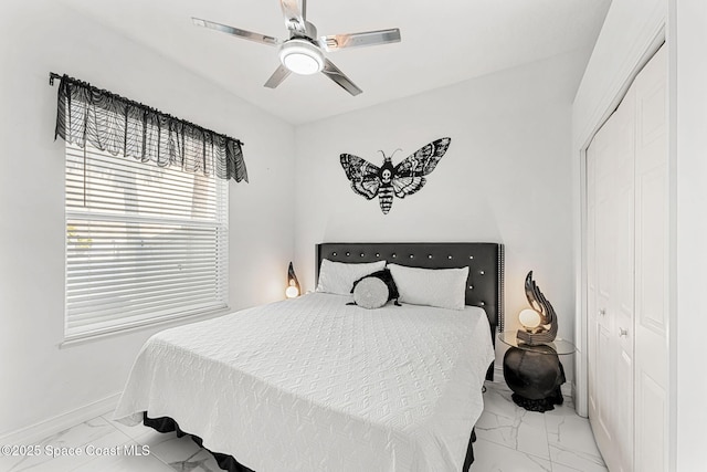 227 Loggerhead Dr, Melbourne Beach, FL 32951 - bedroom featuring light marble finish floors, a closet, and ceiling fan