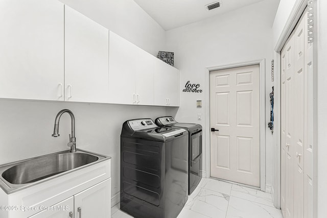 227 Loggerhead Dr, Melbourne Beach, FL 32951 - washroom with cabinet space, washer and clothes dryer, and light marble finish floors