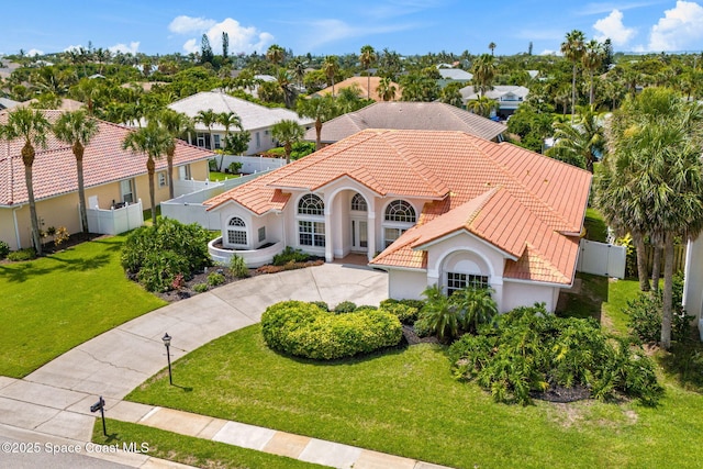 227 Loggerhead Dr, Melbourne Beach, FL 32951 - mediterranean / spanish home with stucco siding, concrete driveway, and a tiled roof