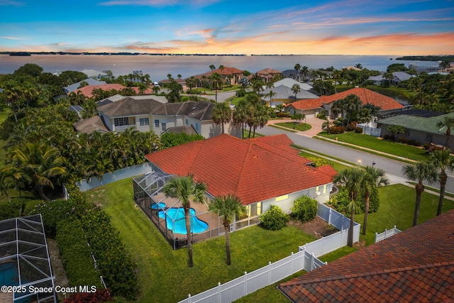 227 Loggerhead Dr, Melbourne Beach, FL 32951 - aerial view at dusk of a water view, view of pool, and a residential view