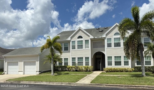 1925 Westminster Cir Unit 1, Vero Beach, FL 32966 - townhome / multi-family property featuring concrete driveway, a garage, and a front lawn