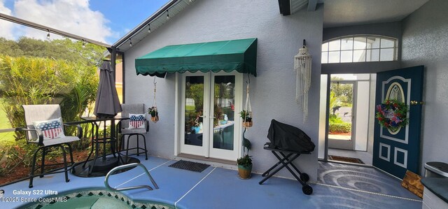 688 Naples Ct, West Melbourne, FL 32904 - view of exterior entry featuring french doors and stucco siding