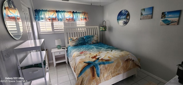 688 Naples Ct, West Melbourne, FL 32904 - tiled bedroom featuring baseboards