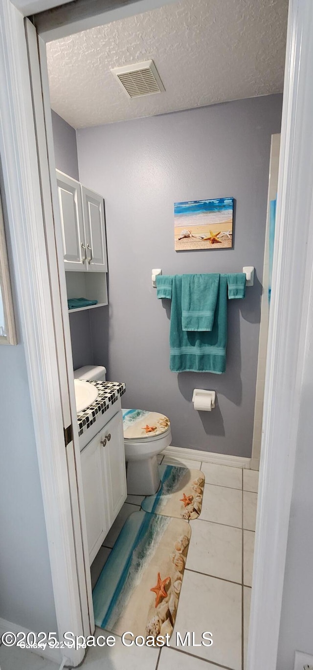 688 Naples Ct, West Melbourne, FL 32904 - bathroom featuring vanity, a textured ceiling, and tile patterned flooring