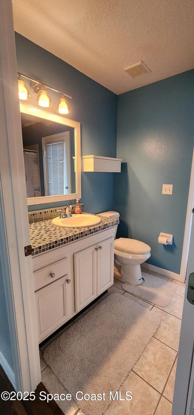 688 Naples Ct, West Melbourne, FL 32904 - bathroom featuring vanity, a textured ceiling, and tile patterned floors