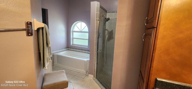 688 Naples Ct, West Melbourne, FL 32904 - bathroom featuring a shower stall, a garden tub, and tile patterned flooring