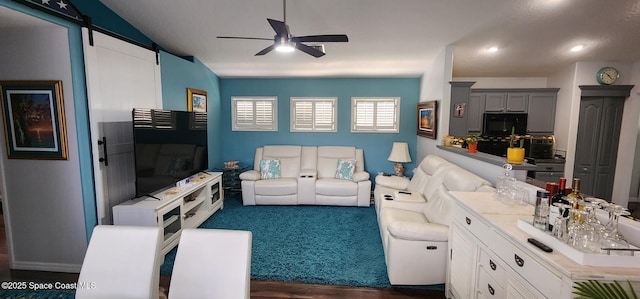 688 Naples Ct, West Melbourne, FL 32904 - living room with a ceiling fan, dark wood finished floors, and a barn door