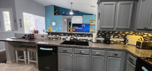 688 Naples Ct, West Melbourne, FL 32904 - kitchen with gray cabinetry, vaulted ceiling, tasteful backsplash, dishwasher, and light tile patterned floors
