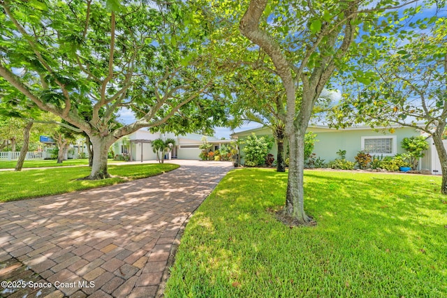 1732 Bay Shore Dr, Cocoa Beach, FL 32931 - view of front of home featuring a front lawn, stucco siding, and decorative driveway