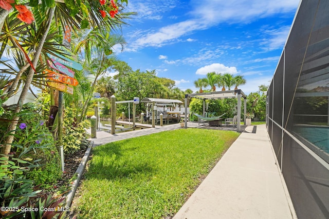 1732 Bay Shore Dr, Cocoa Beach, FL 32931 - view of grassy yard with boat lift, a boat dock, and a lanai
