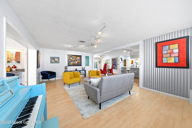 1732 Bay Shore Dr, Cocoa Beach, FL 32931 - living room with light wood-style floors and a textured ceiling