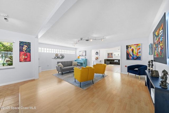 1732 Bay Shore Dr, Cocoa Beach, FL 32931 - living room featuring wood finished floors, healthy amount of natural light, and track lighting
