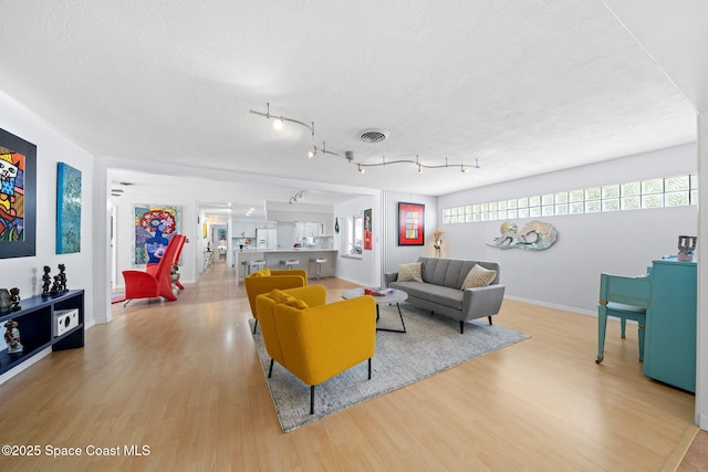 1732 Bay Shore Dr, Cocoa Beach, FL 32931 - living room featuring light wood finished floors and a textured ceiling