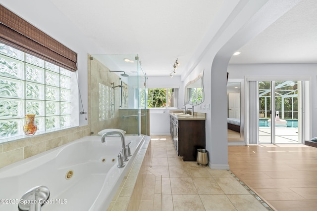 1732 Bay Shore Dr, Cocoa Beach, FL 32931 - bathroom with vanity, a shower stall, a whirlpool tub, tile patterned floors, and recessed lighting