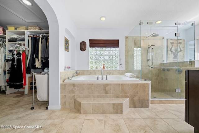 1732 Bay Shore Dr, Cocoa Beach, FL 32931 - bathroom featuring a bath, tile patterned flooring, a shower stall, and a spacious closet