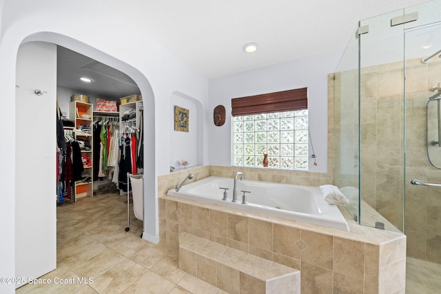 1732 Bay Shore Dr, Cocoa Beach, FL 32931 - full bathroom featuring a garden tub, a stall shower, tile patterned flooring, a walk in closet, and recessed lighting