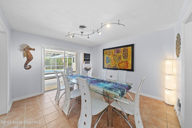 1732 Bay Shore Dr, Cocoa Beach, FL 32931 - dining space with light tile patterned floors and track lighting