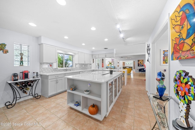 1732 Bay Shore Dr, Cocoa Beach, FL 32931 - kitchen with open shelves, light countertops, light tile patterned flooring, and recessed lighting