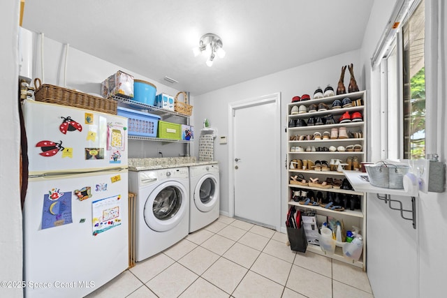 1732 Bay Shore Dr, Cocoa Beach, FL 32931 - laundry area featuring washing machine and clothes dryer and light tile patterned flooring