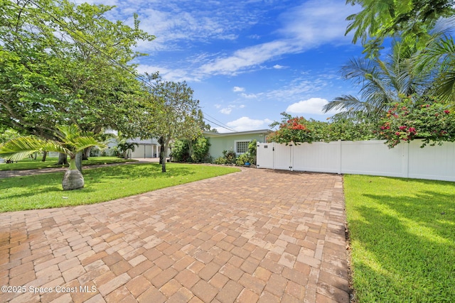 1732 Bay Shore Dr, Cocoa Beach, FL 32931 - view of front of home with a gate and decorative driveway