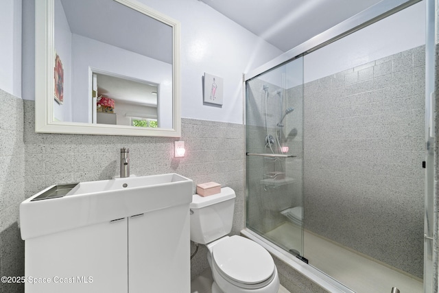 1732 Bay Shore Dr, Cocoa Beach, FL 32931 - bathroom featuring vanity, a shower stall, and tile walls