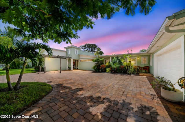 1732 Bay Shore Dr, Cocoa Beach, FL 32931 - view of front of house featuring an attached garage and stucco siding