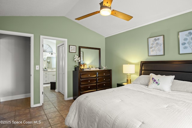 212 Olivick Cir NE, Palm Bay, FL 32907 - bedroom featuring lofted ceiling, ensuite bathroom, tile patterned floors, and a ceiling fan