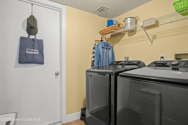 212 Olivick Cir NE, Palm Bay, FL 32907 - washroom with washer and dryer and light wood-style flooring
