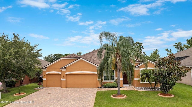 2690 Cypress Tree Trl, Saint Cloud, FL 34772 - view of property hidden behind natural elements with stucco siding, a garage, decorative driveway, and a front lawn