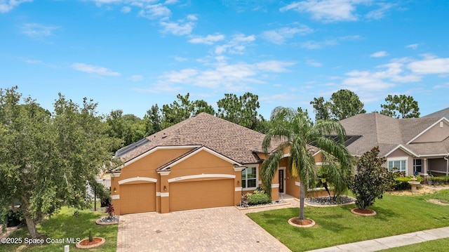2690 Cypress Tree Trl, Saint Cloud, FL 34772 - view of front facade with stucco siding, a garage, decorative driveway, and a front yard