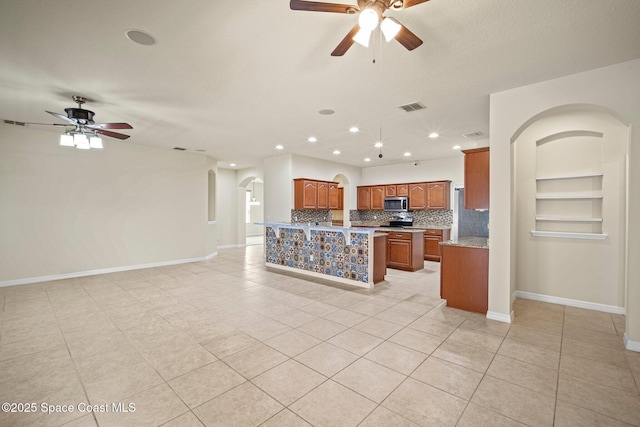 2690 Cypress Tree Trl, Saint Cloud, FL 34772 - kitchen with ceiling fan, arched walkways, appliances with stainless steel finishes, tasteful backsplash, and recessed lighting