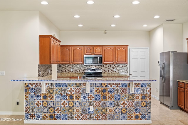 2690 Cypress Tree Trl, Saint Cloud, FL 34772 - kitchen with appliances with stainless steel finishes, recessed lighting, light stone countertops, decorative backsplash, and a peninsula