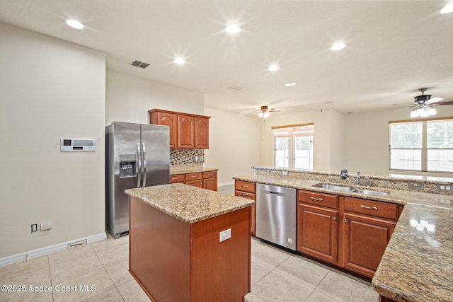 2690 Cypress Tree Trl, Saint Cloud, FL 34772 - kitchen featuring appliances with stainless steel finishes, ceiling fan, a center island, recessed lighting, and light stone counters
