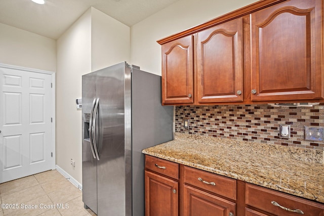 2690 Cypress Tree Trl, Saint Cloud, FL 34772 - kitchen featuring stainless steel fridge, tasteful backsplash, light stone counters, and light tile patterned floors