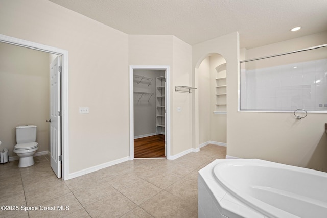 2690 Cypress Tree Trl, Saint Cloud, FL 34772 - full bath featuring a bath, a spacious closet, tile patterned floors, a textured ceiling, and recessed lighting