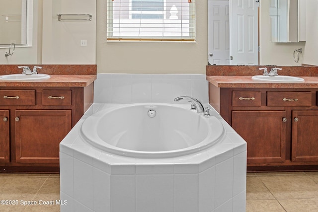 2690 Cypress Tree Trl, Saint Cloud, FL 34772 - bathroom featuring two vanities, tile patterned floors, and a garden tub