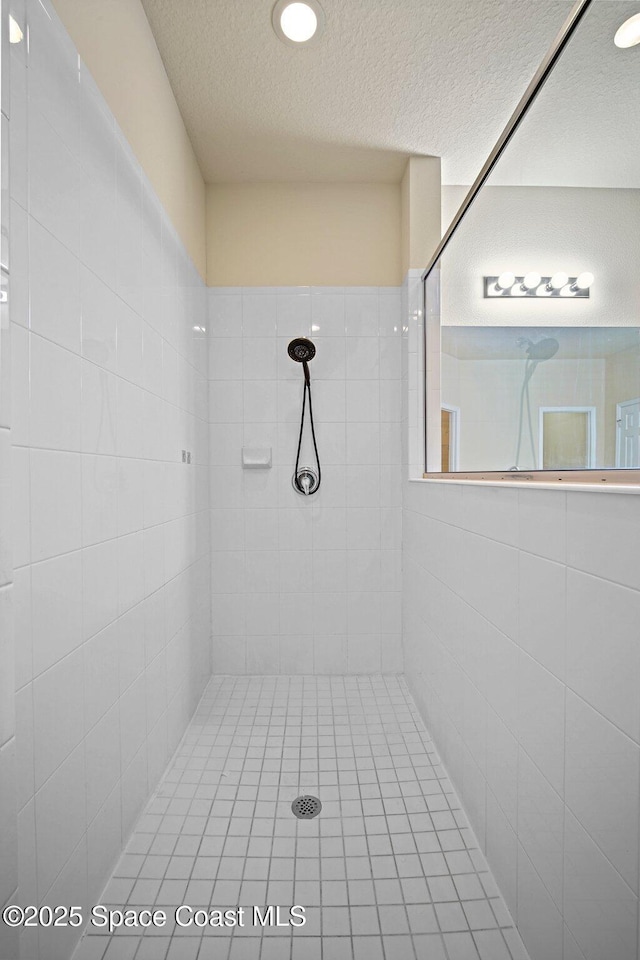 2690 Cypress Tree Trl, Saint Cloud, FL 34772 - full bathroom with tiled shower and a textured ceiling