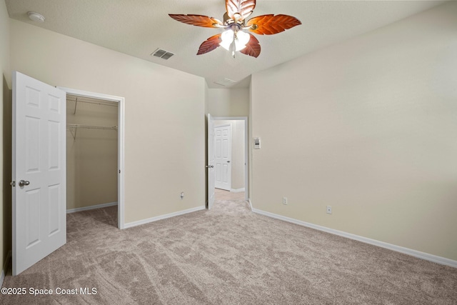 2690 Cypress Tree Trl, Saint Cloud, FL 34772 - unfurnished bedroom with carpet flooring, a walk in closet, and ceiling fan