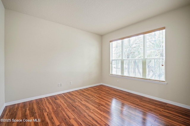 2690 Cypress Tree Trl, Saint Cloud, FL 34772 - empty room with healthy amount of natural light and wood finished floors