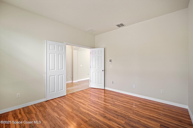 2690 Cypress Tree Trl, Saint Cloud, FL 34772 - unfurnished bedroom with baseboards and wood finished floors