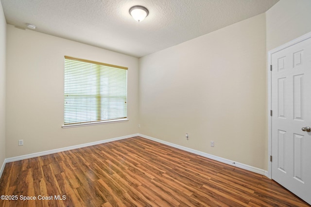 2690 Cypress Tree Trl, Saint Cloud, FL 34772 - unfurnished room featuring wood finished floors, a textured ceiling, and a smoke detector