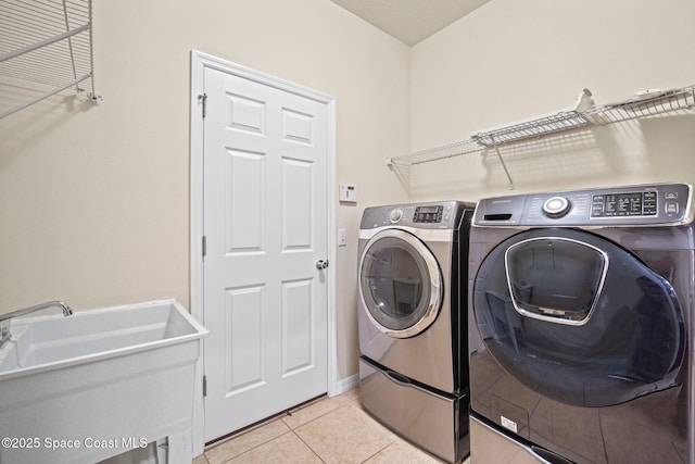 2690 Cypress Tree Trl, Saint Cloud, FL 34772 - laundry area with washing machine and clothes dryer and light tile patterned flooring