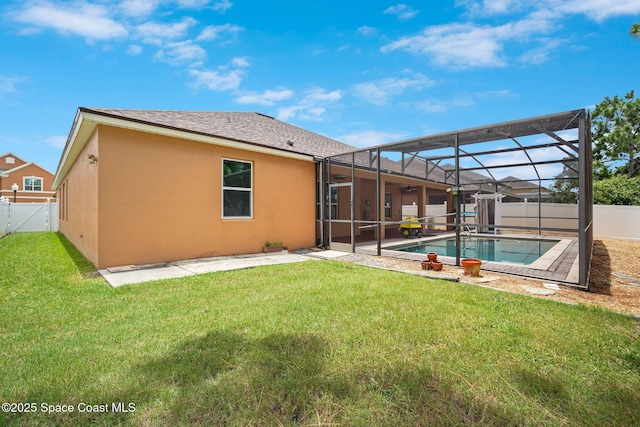 2690 Cypress Tree Trl, Saint Cloud, FL 34772 - back of house with a fenced backyard, a patio, stucco siding, and glass enclosure