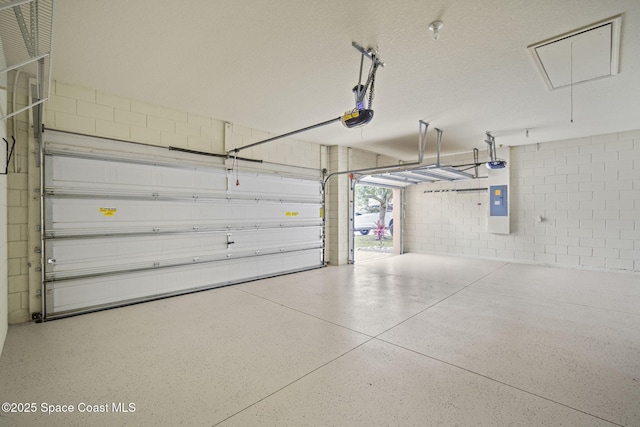 2690 Cypress Tree Trl, Saint Cloud, FL 34772 - garage featuring a garage door opener, concrete block wall, and electric panel
