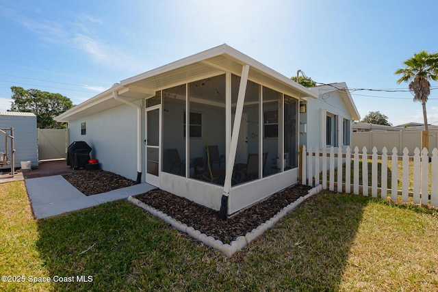 858 Bianca Dr NE, Palm Bay, FL 32905 - back of house featuring a sunroom and stucco siding