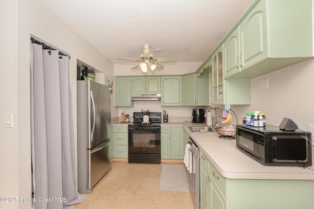 858 Bianca Dr NE, Palm Bay, FL 32905 - kitchen with green cabinetry, black appliances, and under cabinet range hood